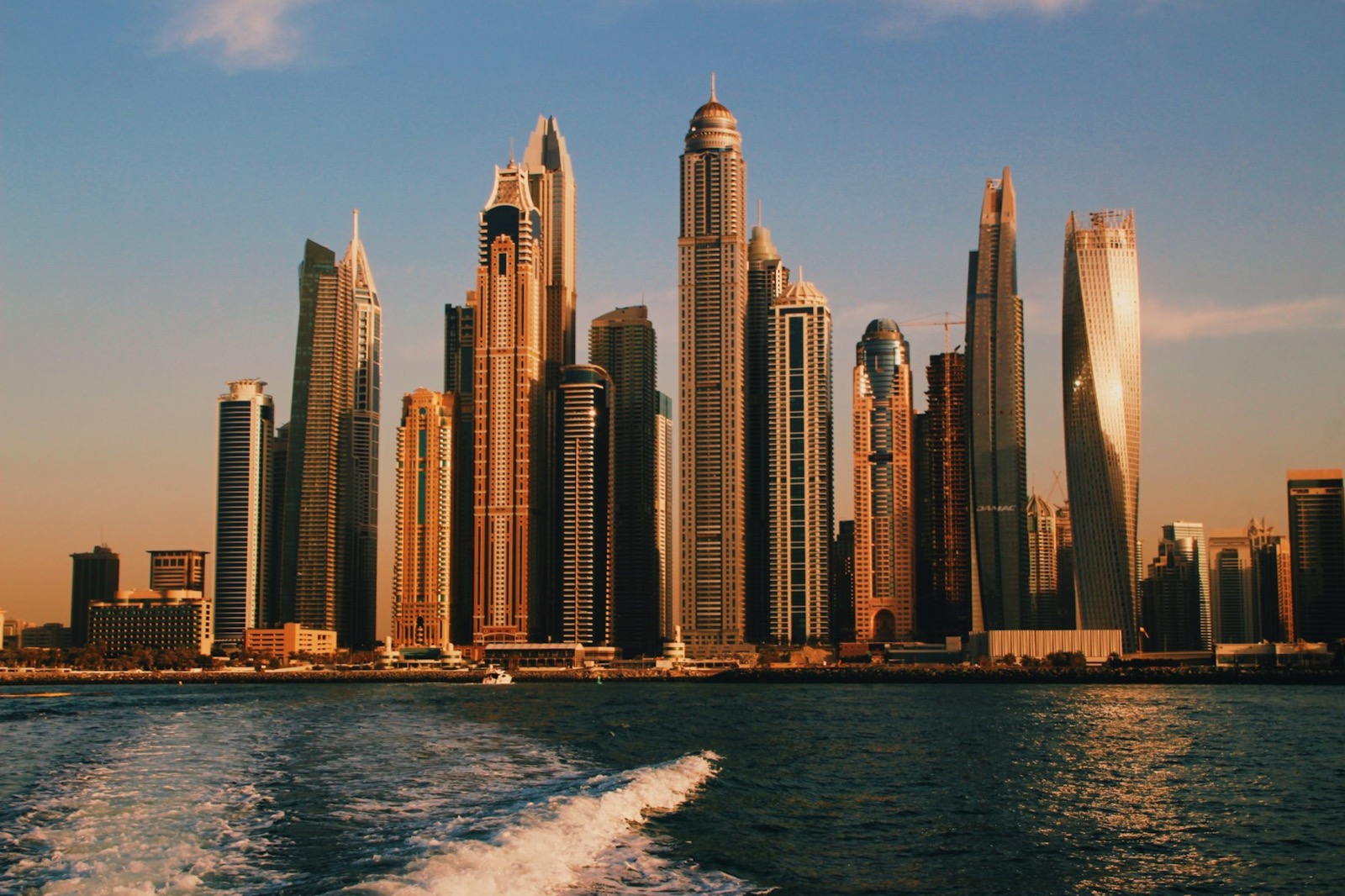 Dubai Marina towers at sunset seen from the water