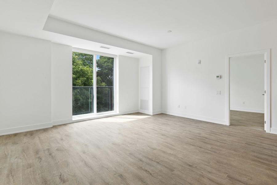 A newly finished Dubai Marina apartment, sunlight through the sliding balcony doors onto the floor